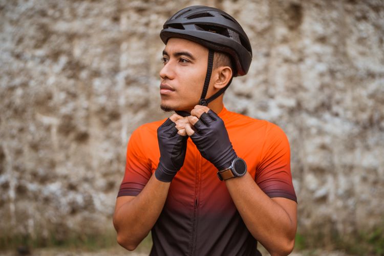 Close-up of a man doing up his cycling helmet