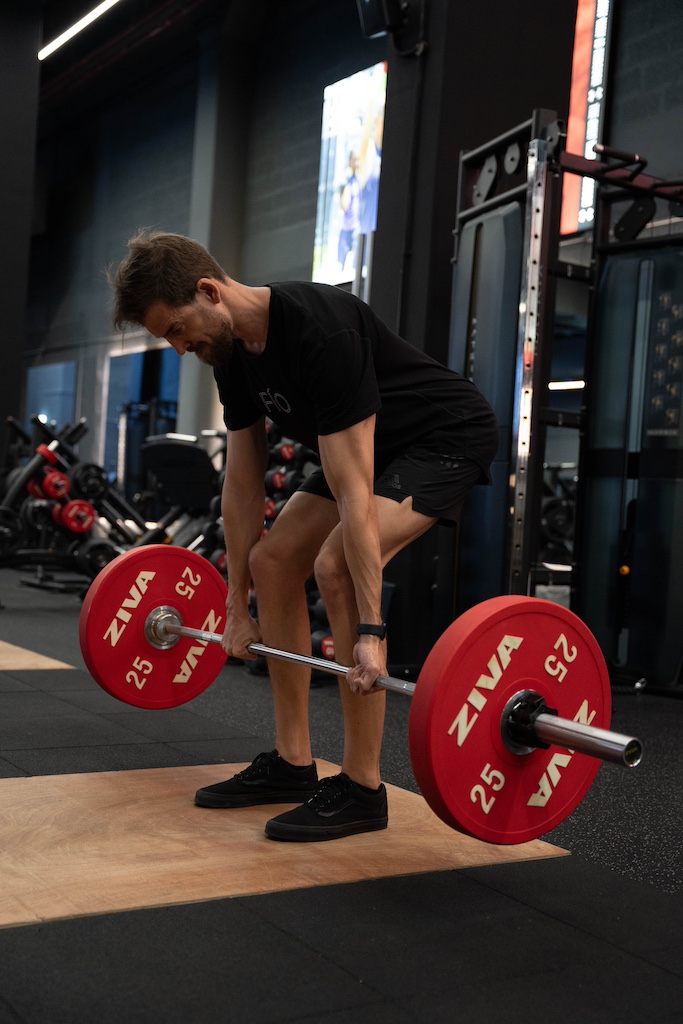 PT demonstrating how to perform a deadlift