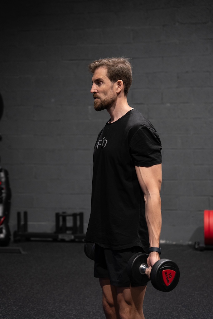 PT demonstrating how to perform a dumbbell curl