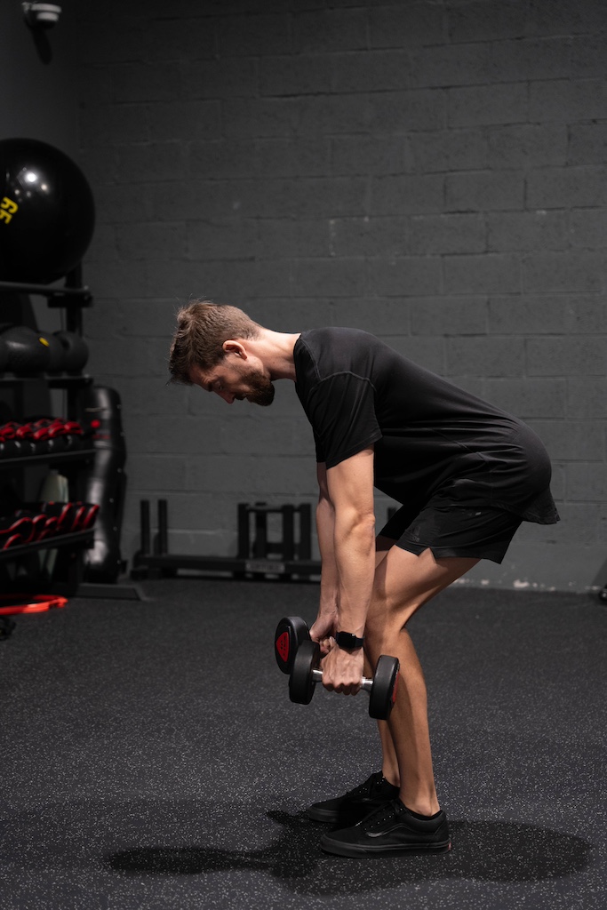 PT demonstrating how to perform a dumbbell row