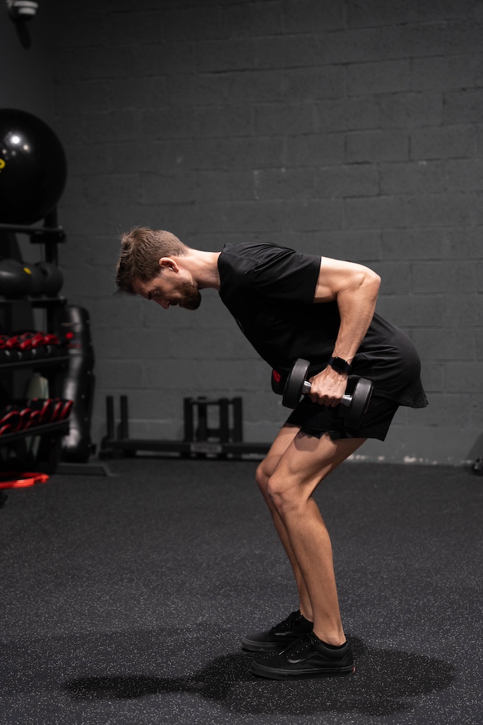 PT demonstrating how to perform a dumbbell row