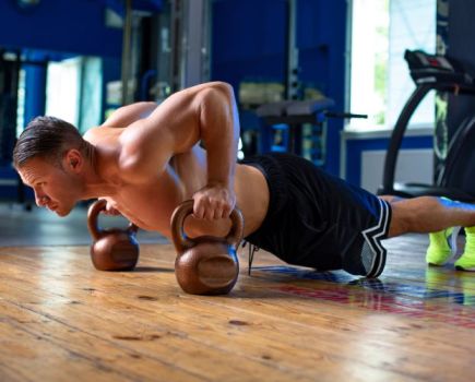 Man performing kettlebell press-ups