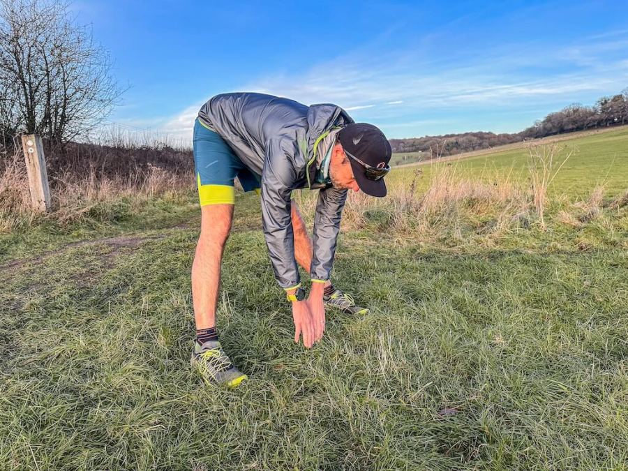 running coach Simon James performs a hamstring stretch as part of a post-run stretching routine