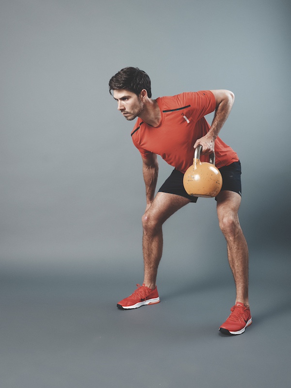 man in fitness kit demonstrating how to do a kettlebell bent-over row 