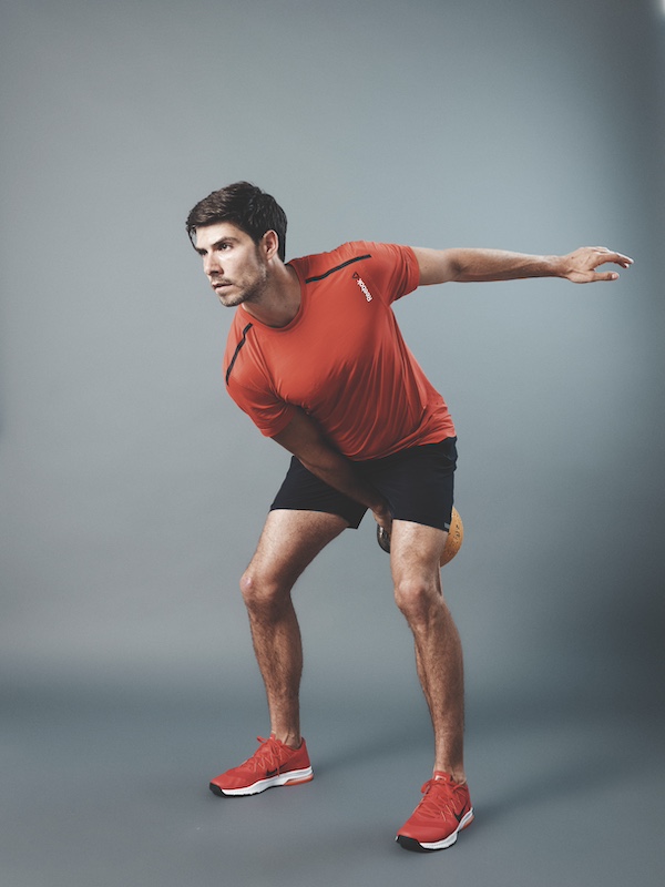 fitness model demonstrating how to do the kettlebell clean and press