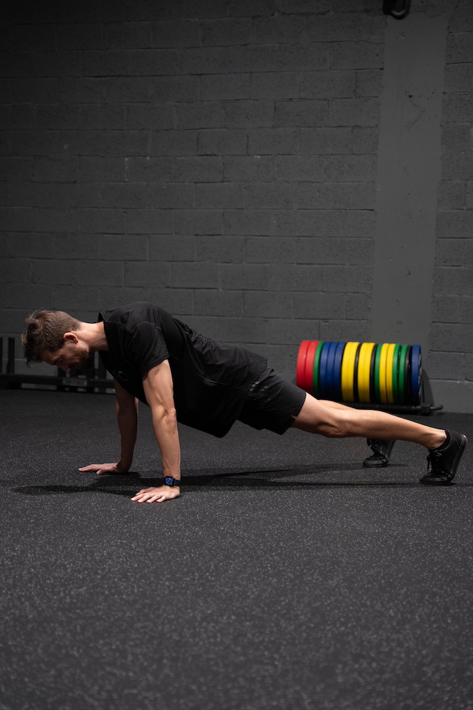 PT demonstrating how to perform a push-up