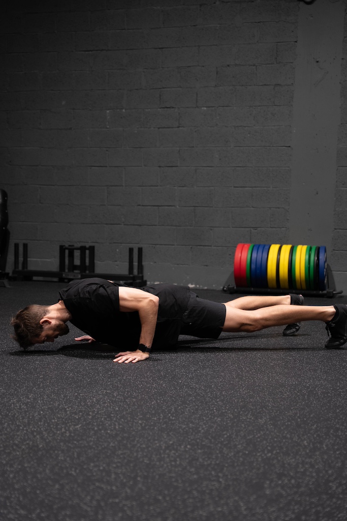 PT demonstrating how to perform a push-up