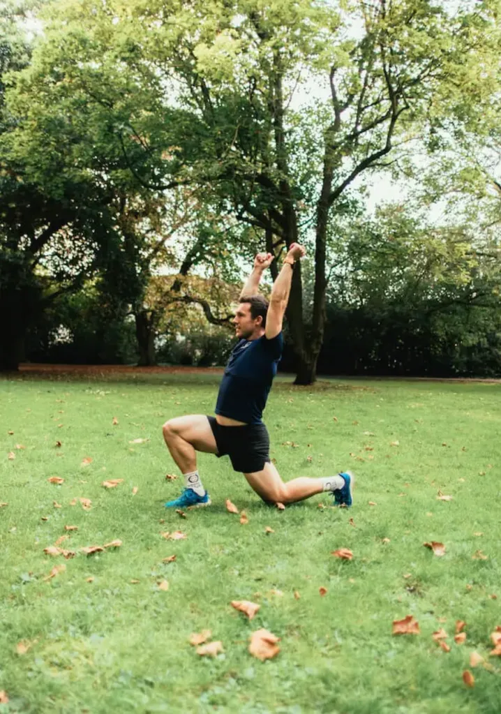 Man performing a lunge with overhead reach