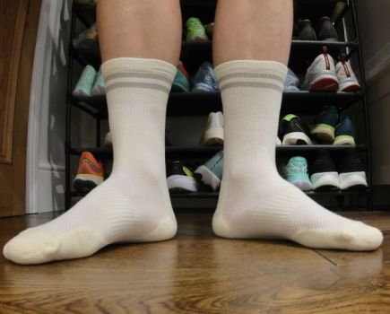 Close-up of a man's feet wearing Tracksmith running socks