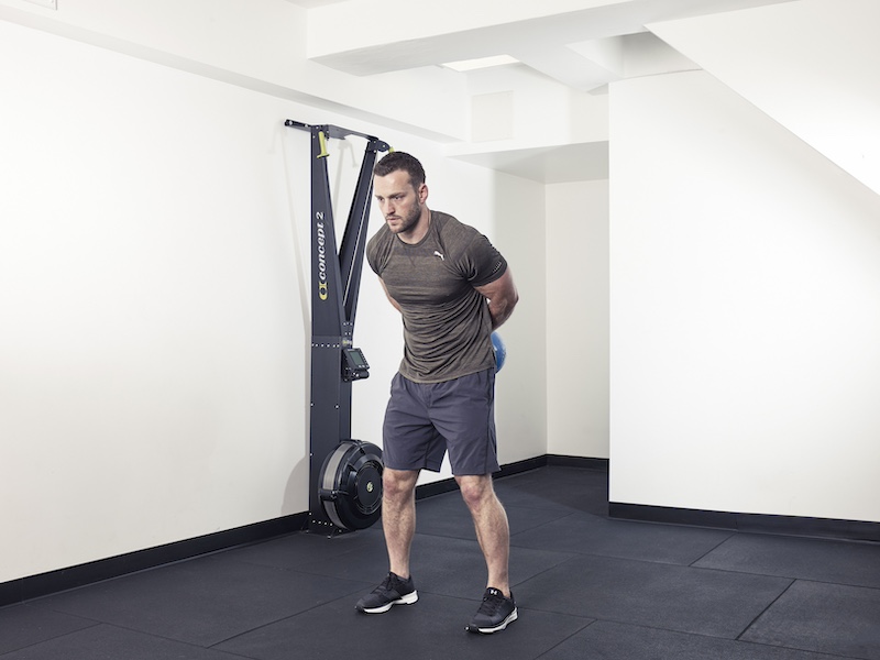 fitness model demonstrating how to perform a kettlebell round the world