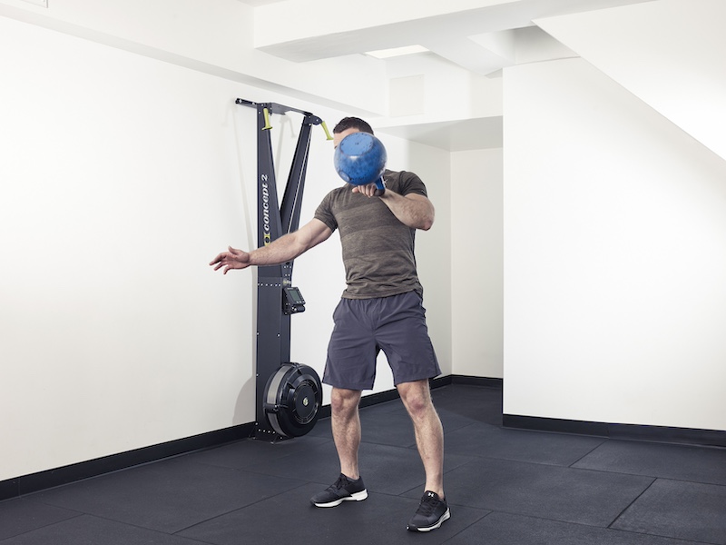 fitness model demonstrating how to perform a kettlebell snatch