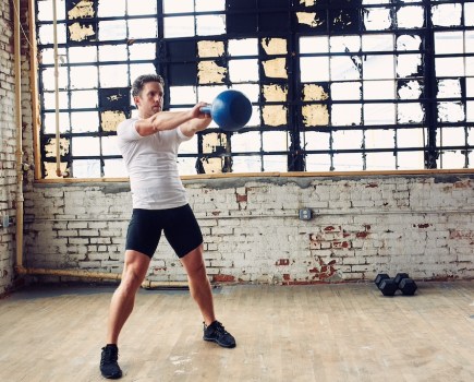 man showing how to do a kettlebell swing