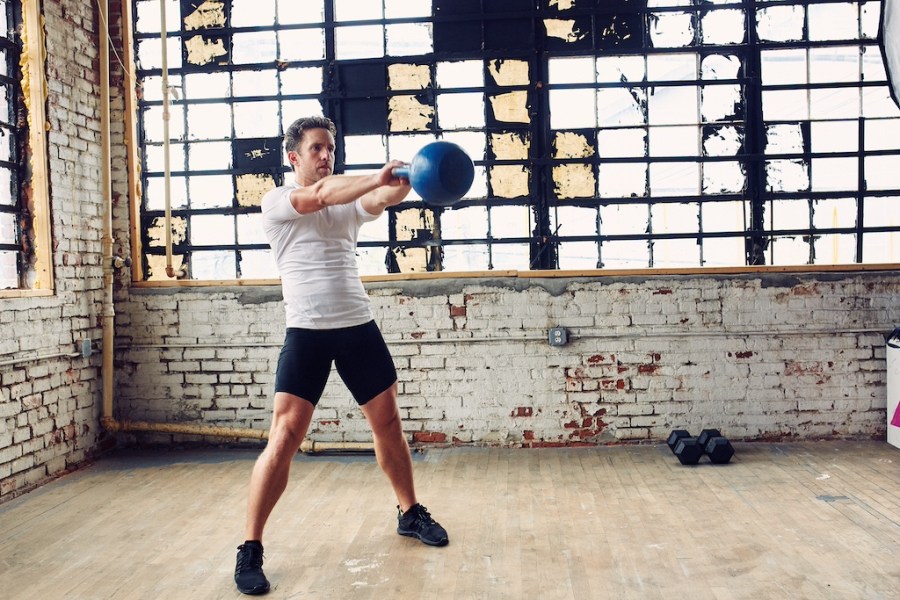 man showing how to do a kettlebell swing