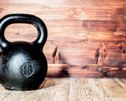 black kettlebell on wooden floor