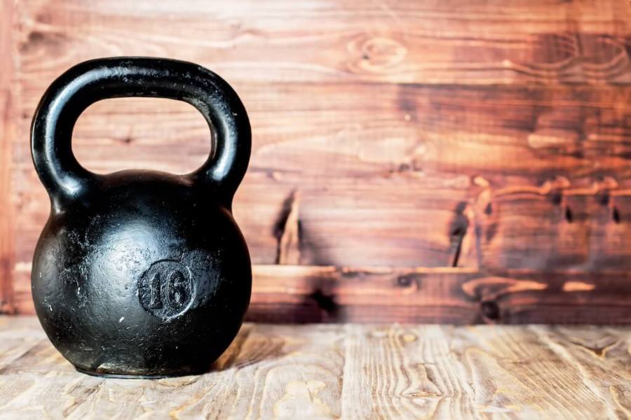 black kettlebell on wooden floor