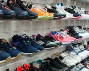 cushioned running shoes on shelves in sports shop