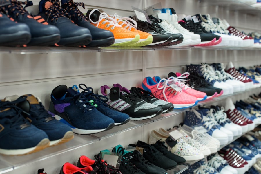 cushioned running shoes on shelves in sports shop