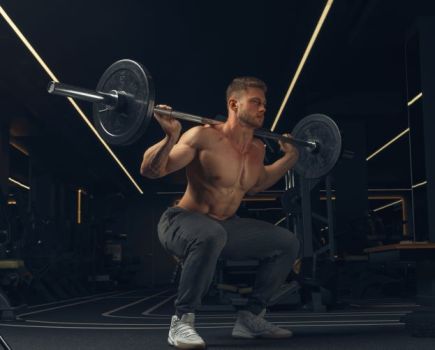 Man performing barbell squats