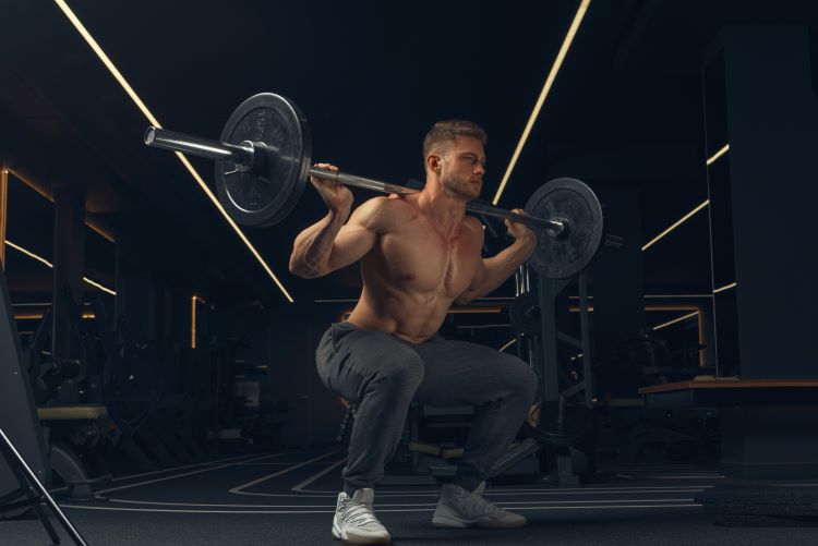 Man performing barbell squats