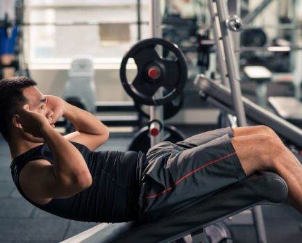 Man doing sit-ups on an incline bench