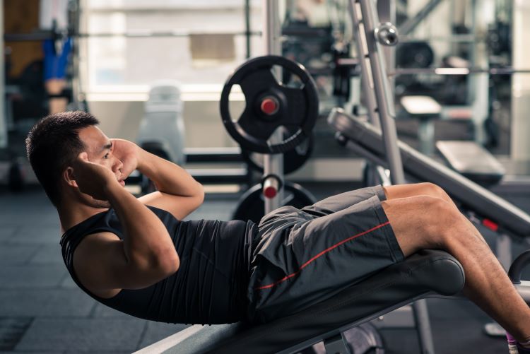 Man doing sit-ups on an incline bench