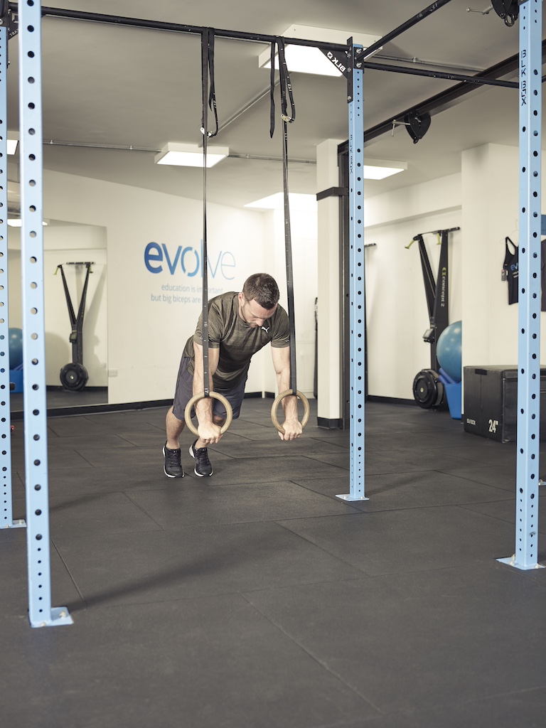 man performing a push-up with a suspension trainer