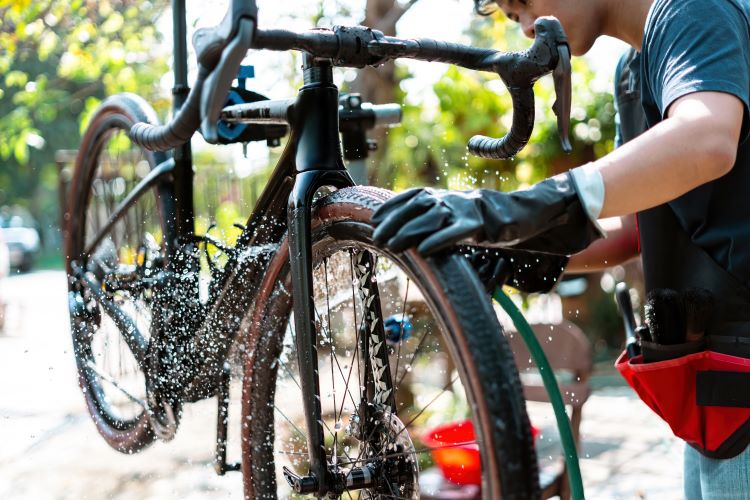 Close-up of a man washing an e-bike