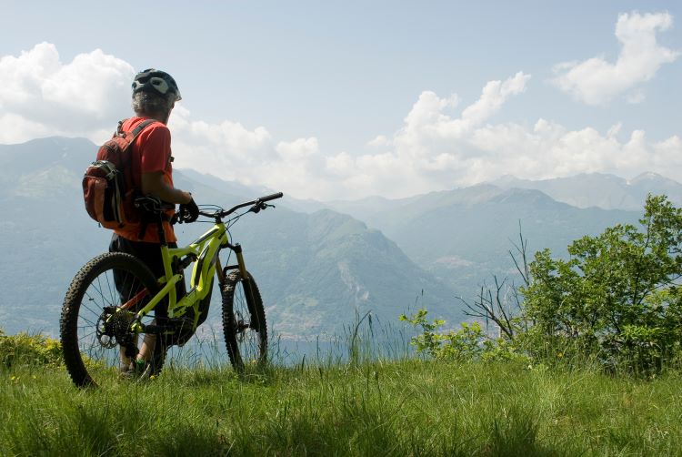 Man on e-bike with mountains in the distance