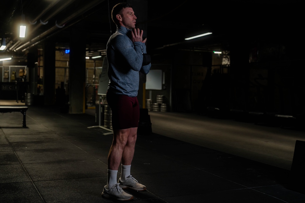 man performing goblet squat as part of a small-space dumbbell workout