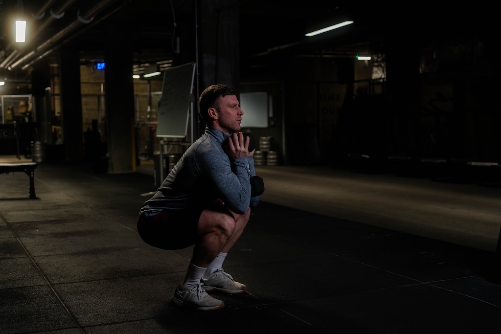 man performing dumbbell goblet squat