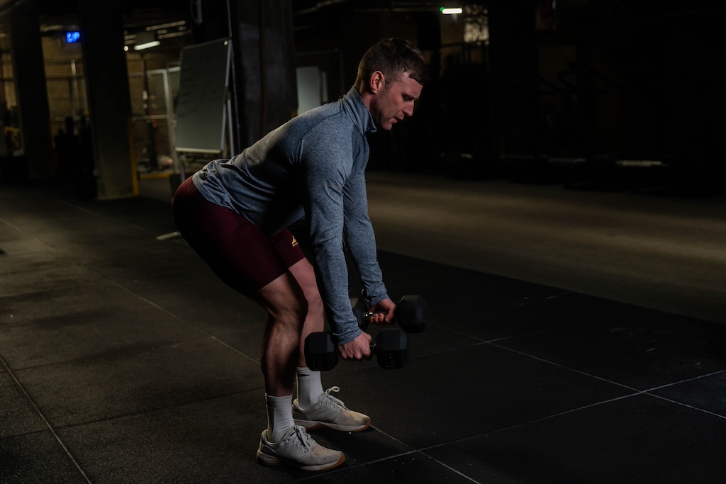 man performing dumbbell row