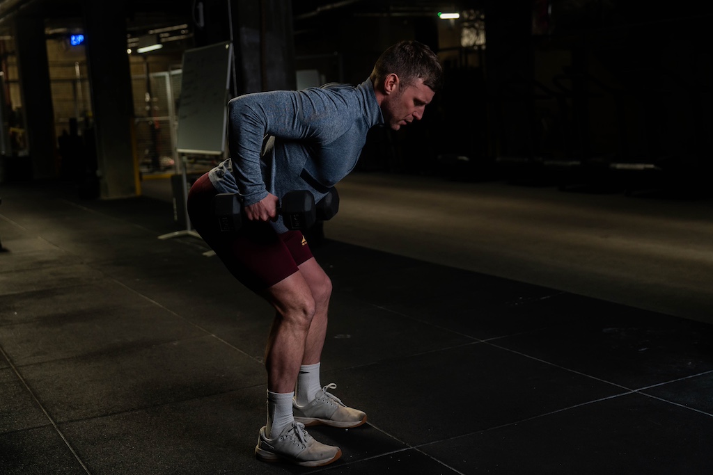 man performing dumbbell row