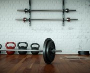gym floor with barbell and kettlebells