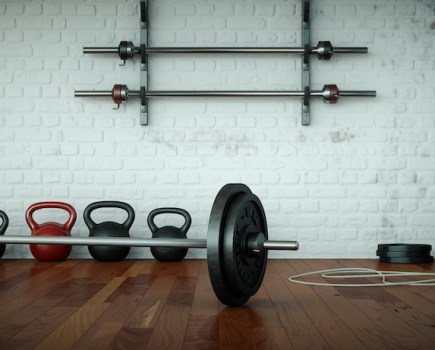 gym floor with barbell and kettlebells