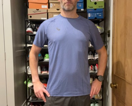 Mid-torso shot of a man wearing a running tee