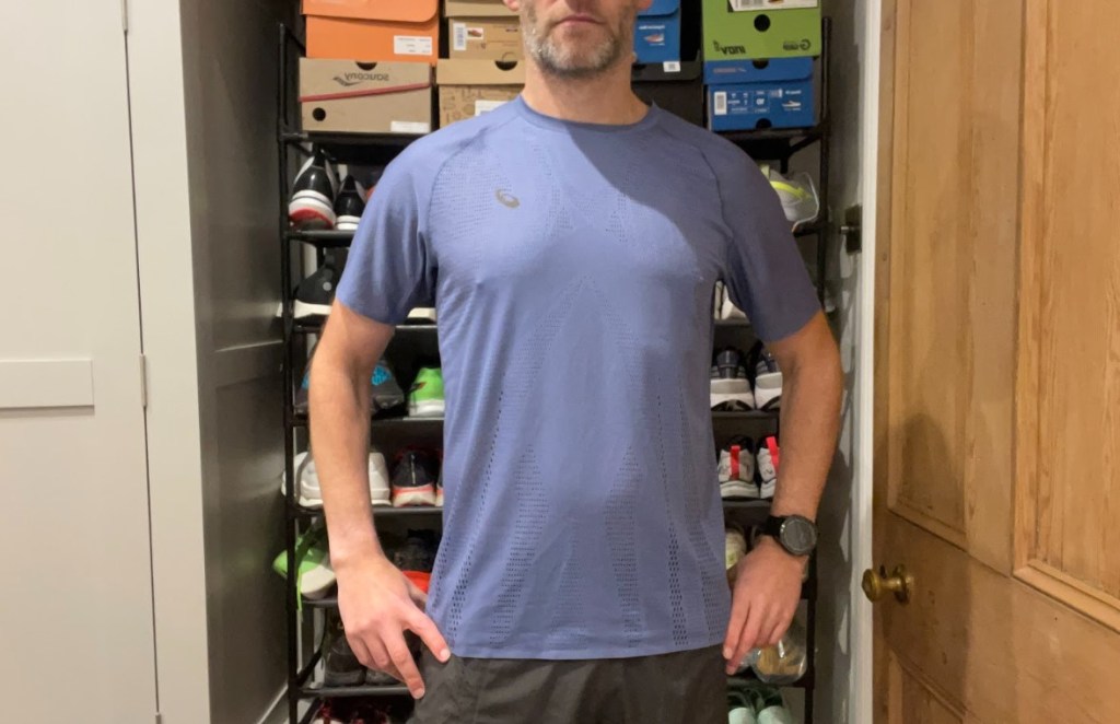 Mid-torso shot of a man wearing a running tee