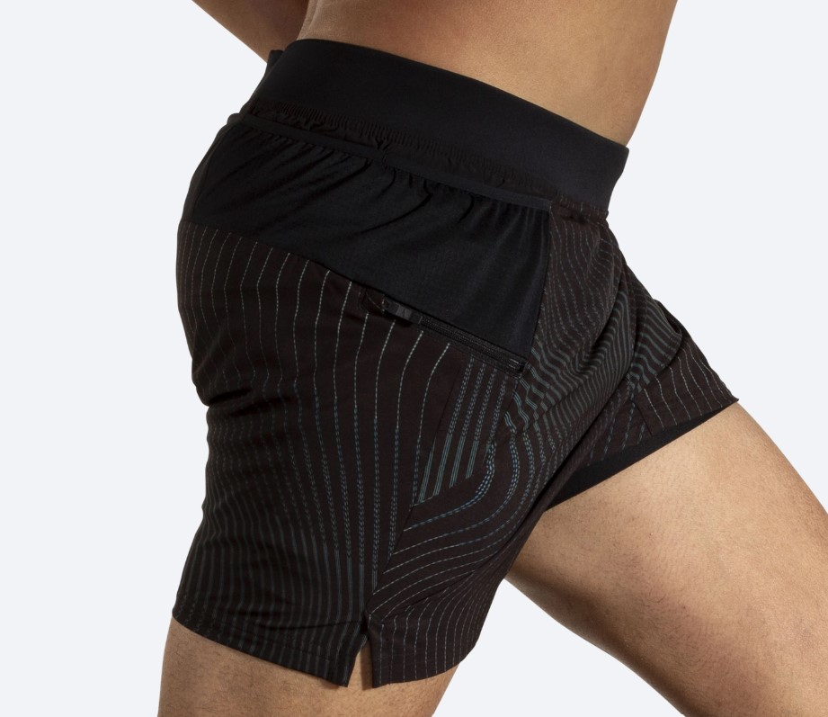 Mid-torso close-up of a man wearing running shorts