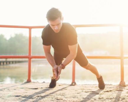 Man doing clapping press-ups outside