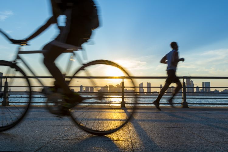 Cyclist and runner going in opposite directions