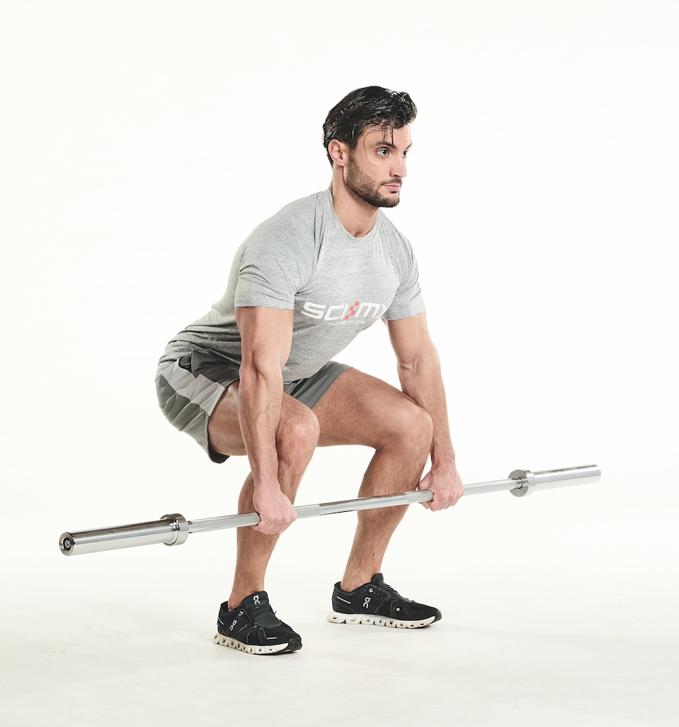 man perfuming barbell deadlift as part of the busy man's training plan