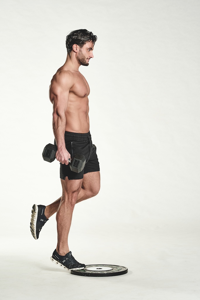 man performing dumbbell calf raise