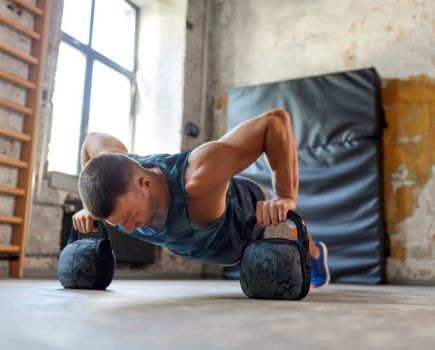 Man performing a kettlebell press up