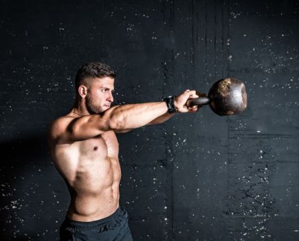 Man performing a kettlebell swing
