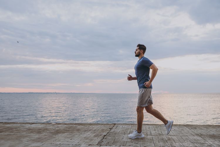 Man cooling down after running by the sea