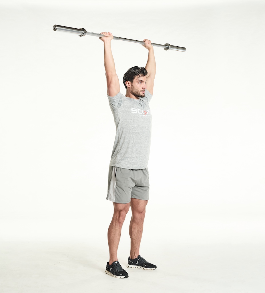 man performing barbell overhead press