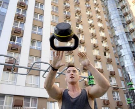 Man outside throwing a kettlebell