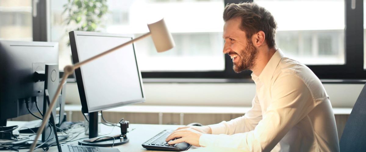 man accessing online therapy on computer for mental health