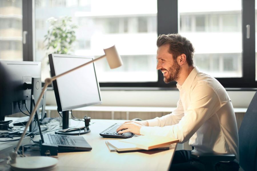 man accessing online therapy on computer for mental health