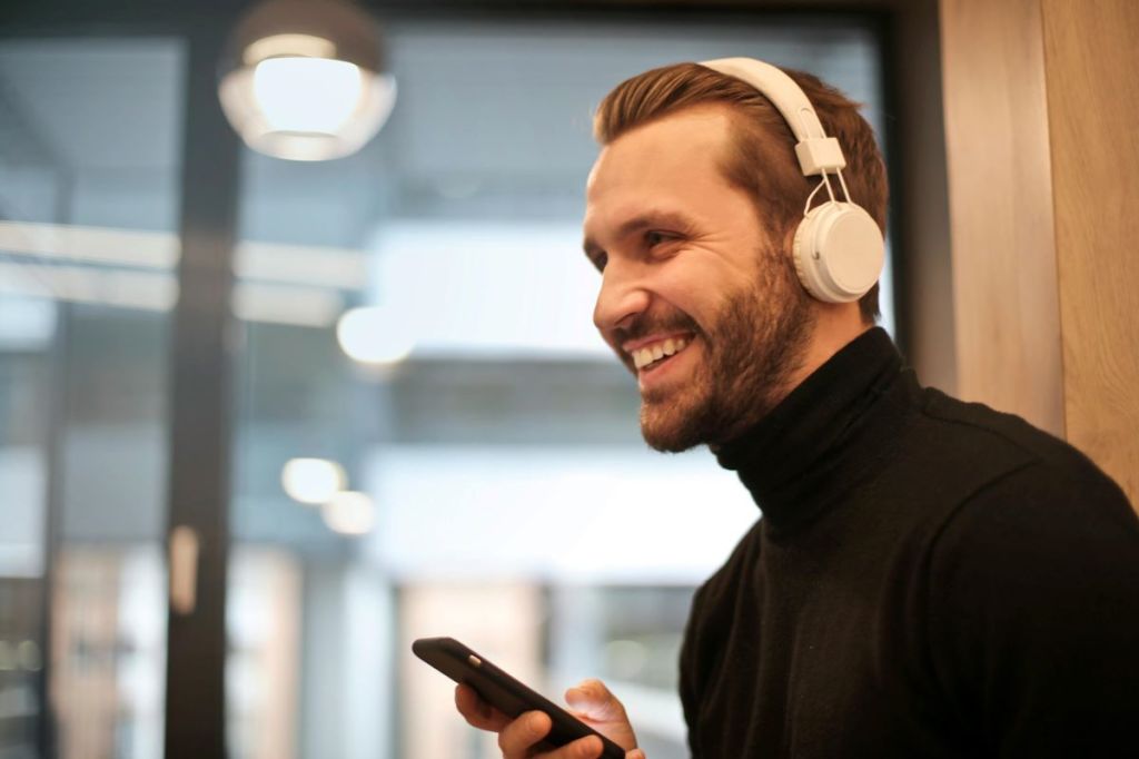 man using phone to access online therapy for mental health