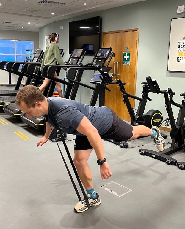 Man performing a resistance band single-leg deadlift